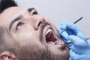 A,Young,Man,Undergoing,Treatment,In,A,Dental,Clinic.,The