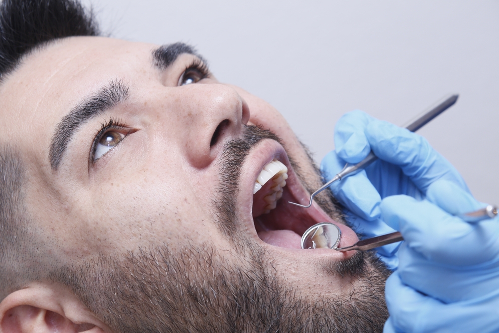 A,Young,Man,Undergoing,Treatment,In,A,Dental,Clinic.,The